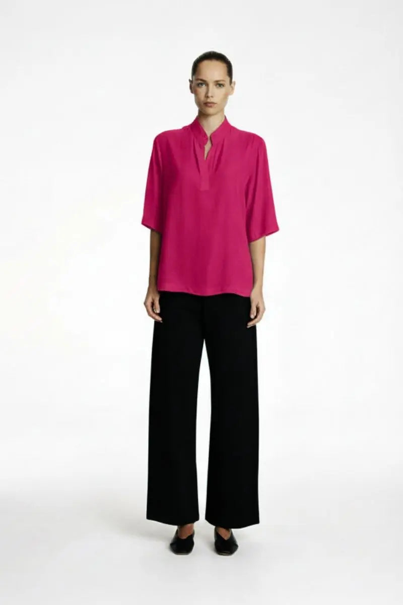 Women Wearing Placket Plaza in Teaberry colour with black wide leg pants front view on a white background 