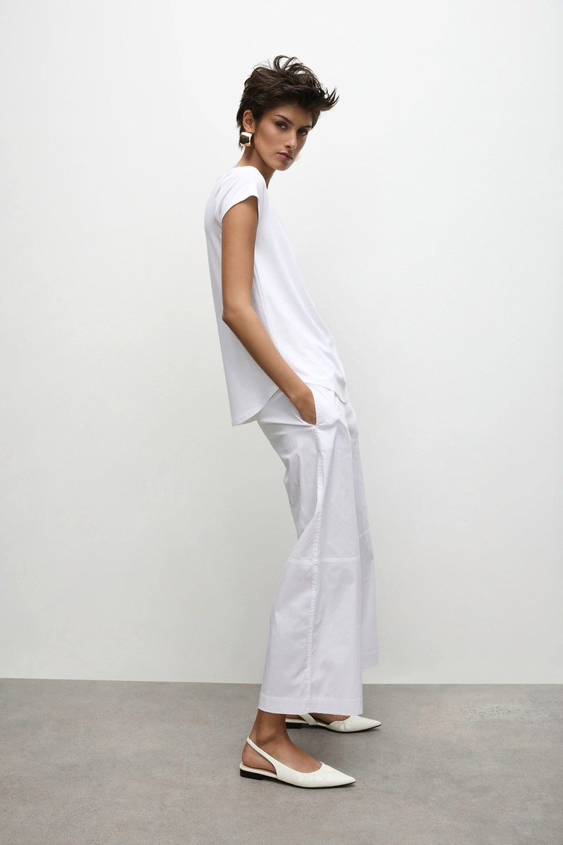 Woman wearing Mela Purdie Slice Pace Pant F65 1825 in white on white background