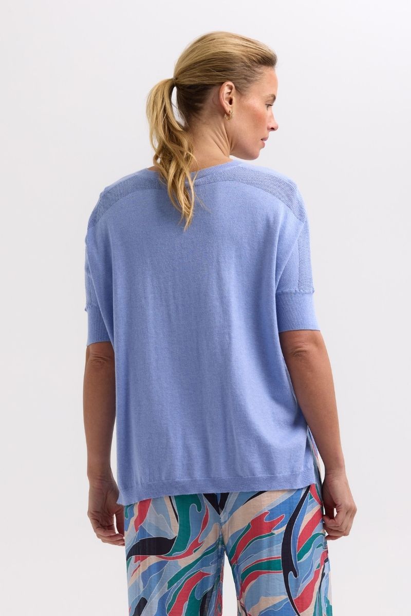 Woman wearing a light blue sweater Back view