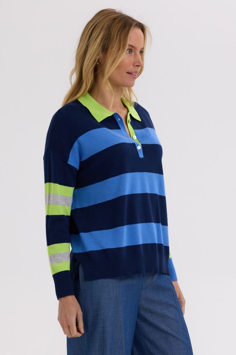 Woman wearing a blue and green striped sweater on a white background