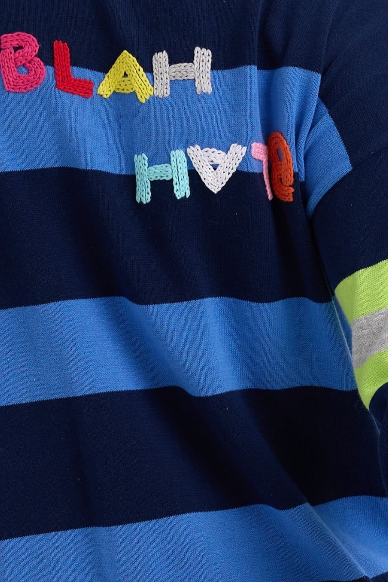 Striped shirt with colorful text 'BLAH BLAH BLAH' on a blue background