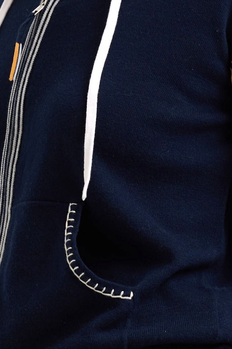 Close view of Navy blue jacket with white zipper and trim details