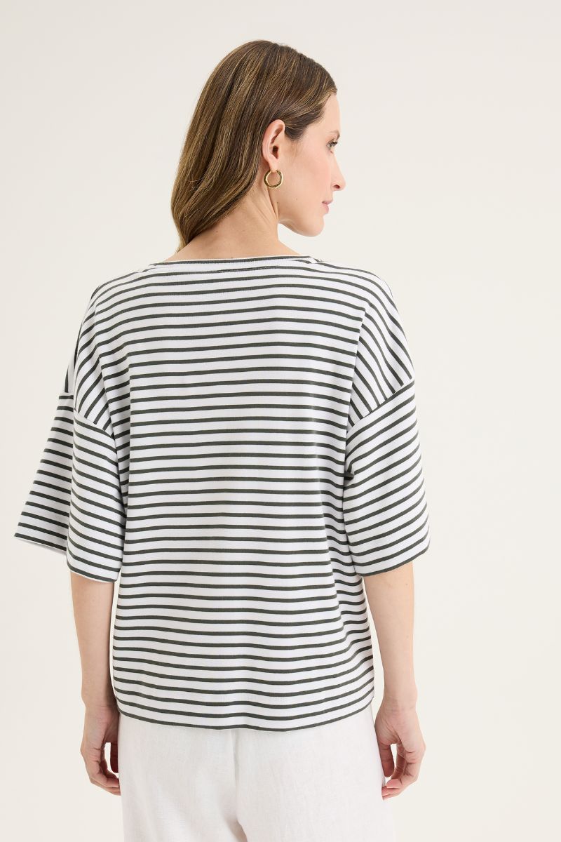 Woman wearing a striped shirt on a plain background
