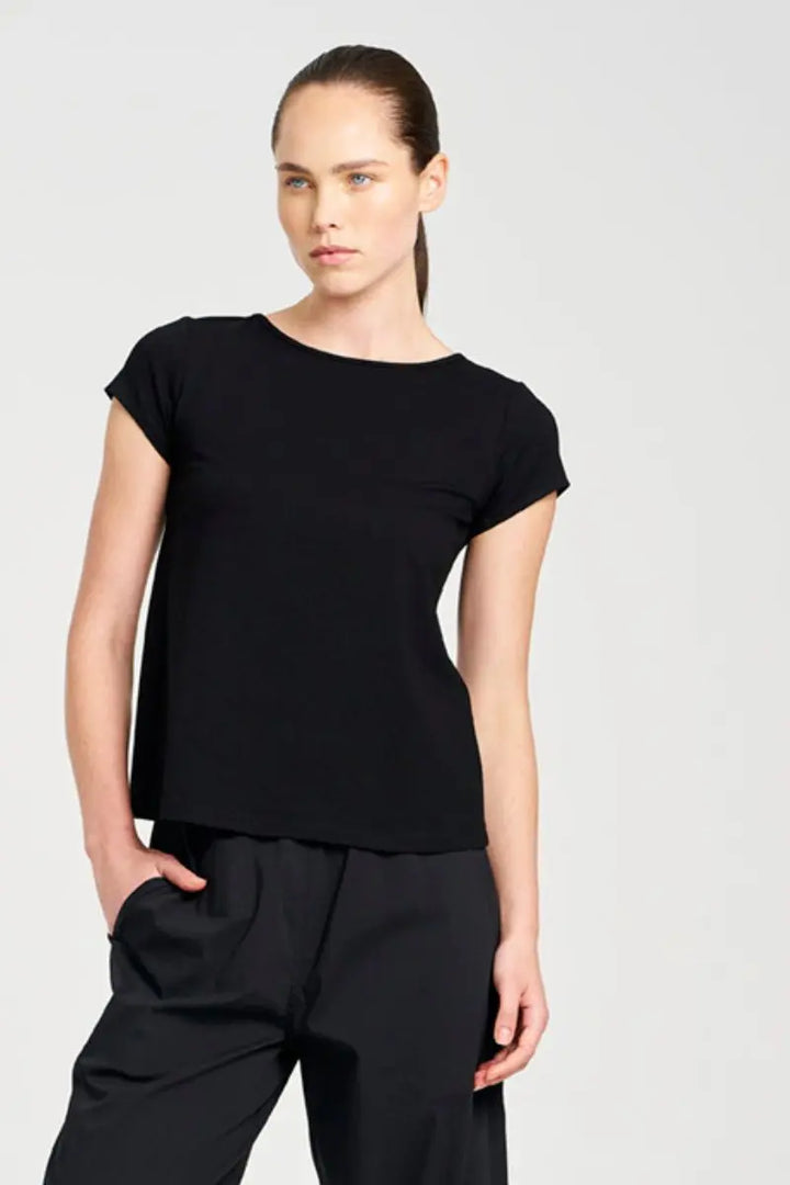 Person wearing a black t-shirt and pants on a white background