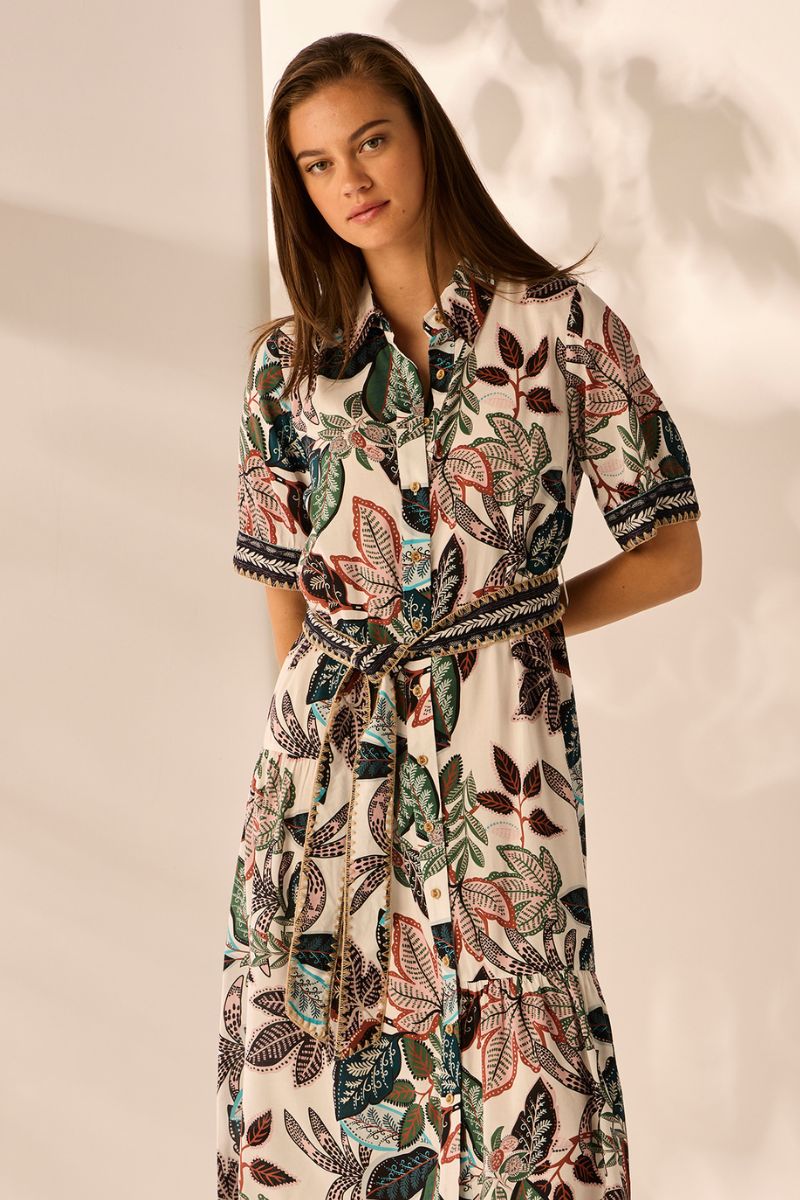 Woman wearing a patterned dress against a neutral background