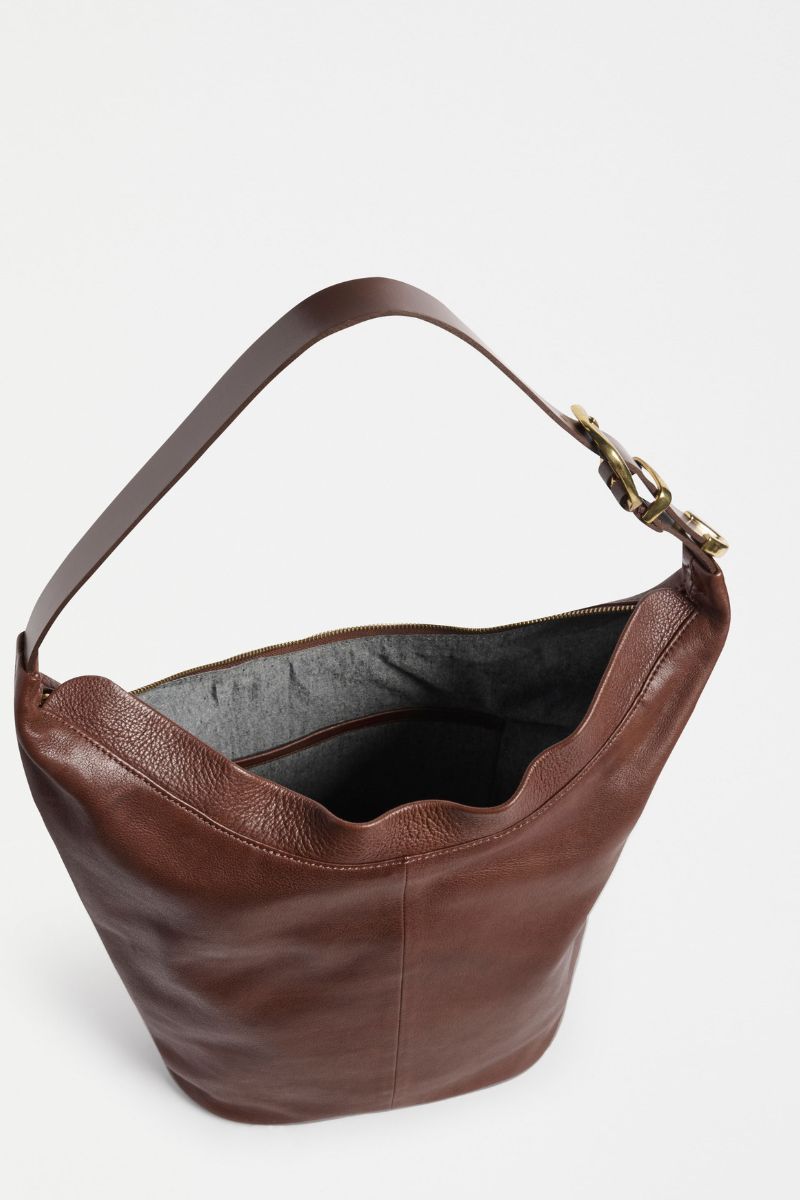 Brown leather handbag on a light gray background