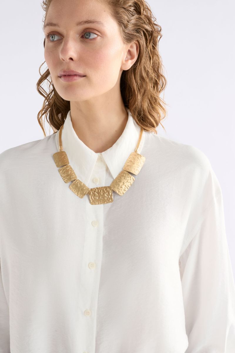 Woman wearing Kilta Necklace by Elk the Label N0259A styled on neckline