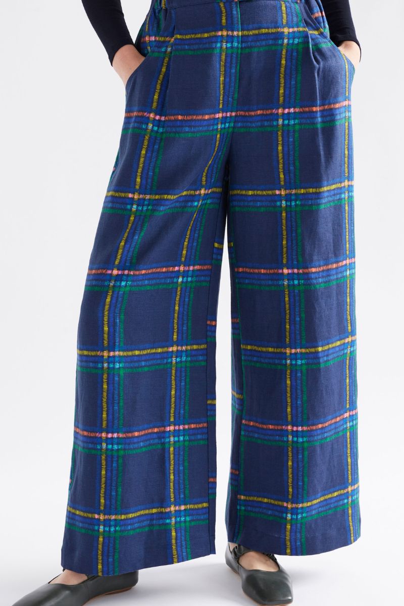 Navy plaid pants worn by a person on a white background