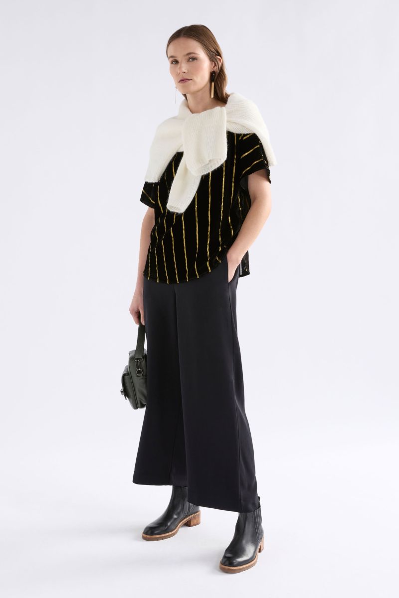 Woman wearing Lumii Top in black and gold by Elk the Label styled