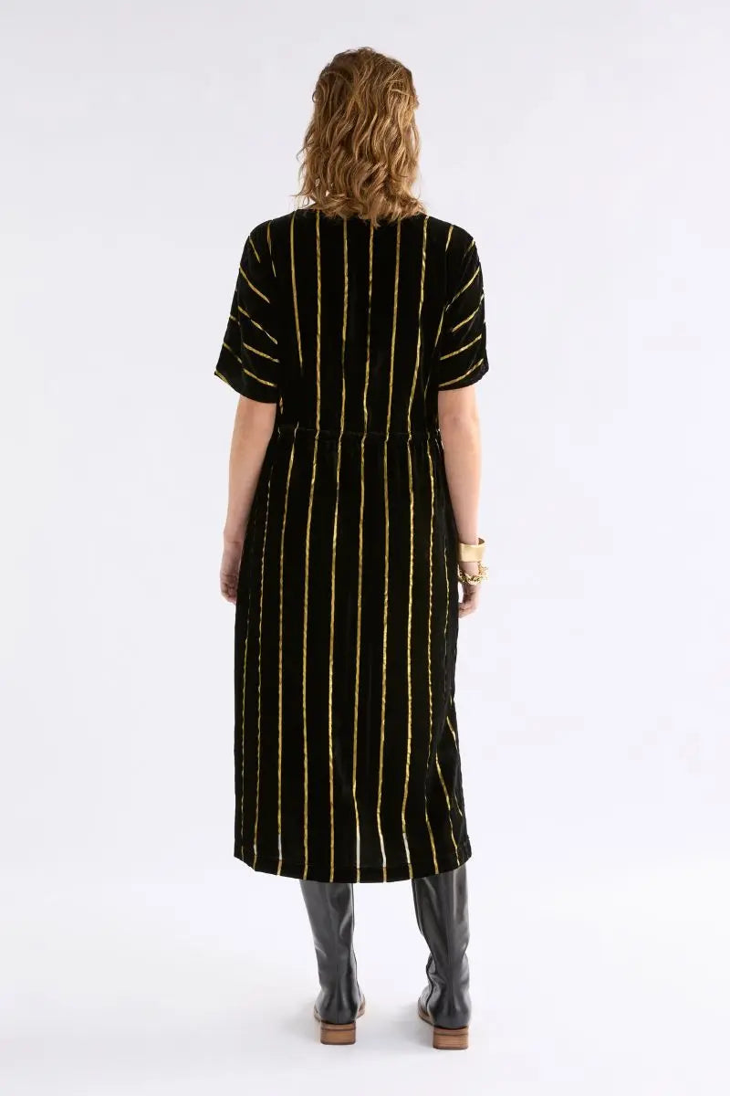 Woman wearing Lumii Dress in Black and Gold by Elk the Label back