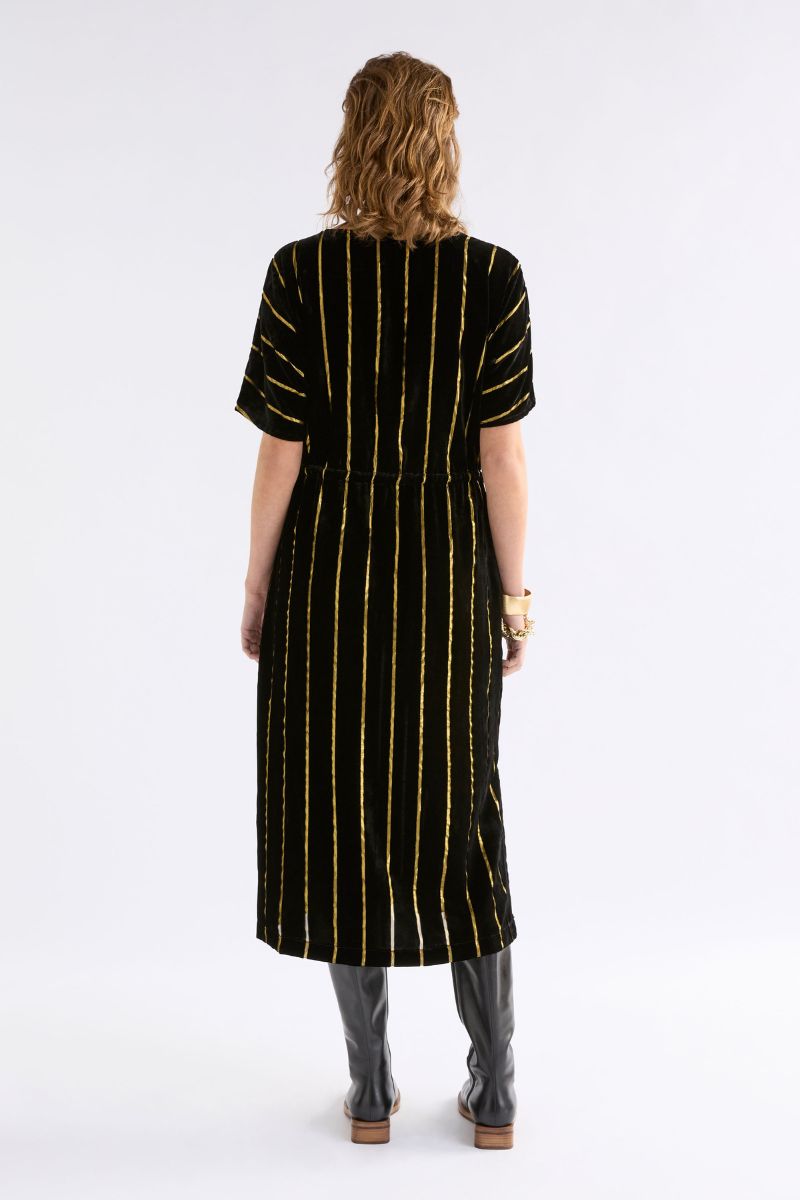 Woman wearing Lumii Dress in Black and Gold by Elk the Label back