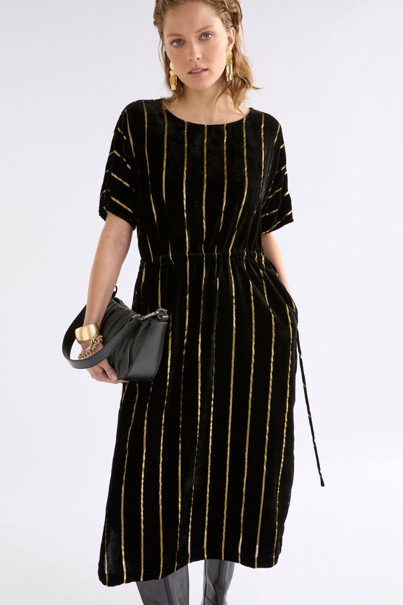 Woman wearing Lumii Dress in Black and Gold by Elk the Label closeup