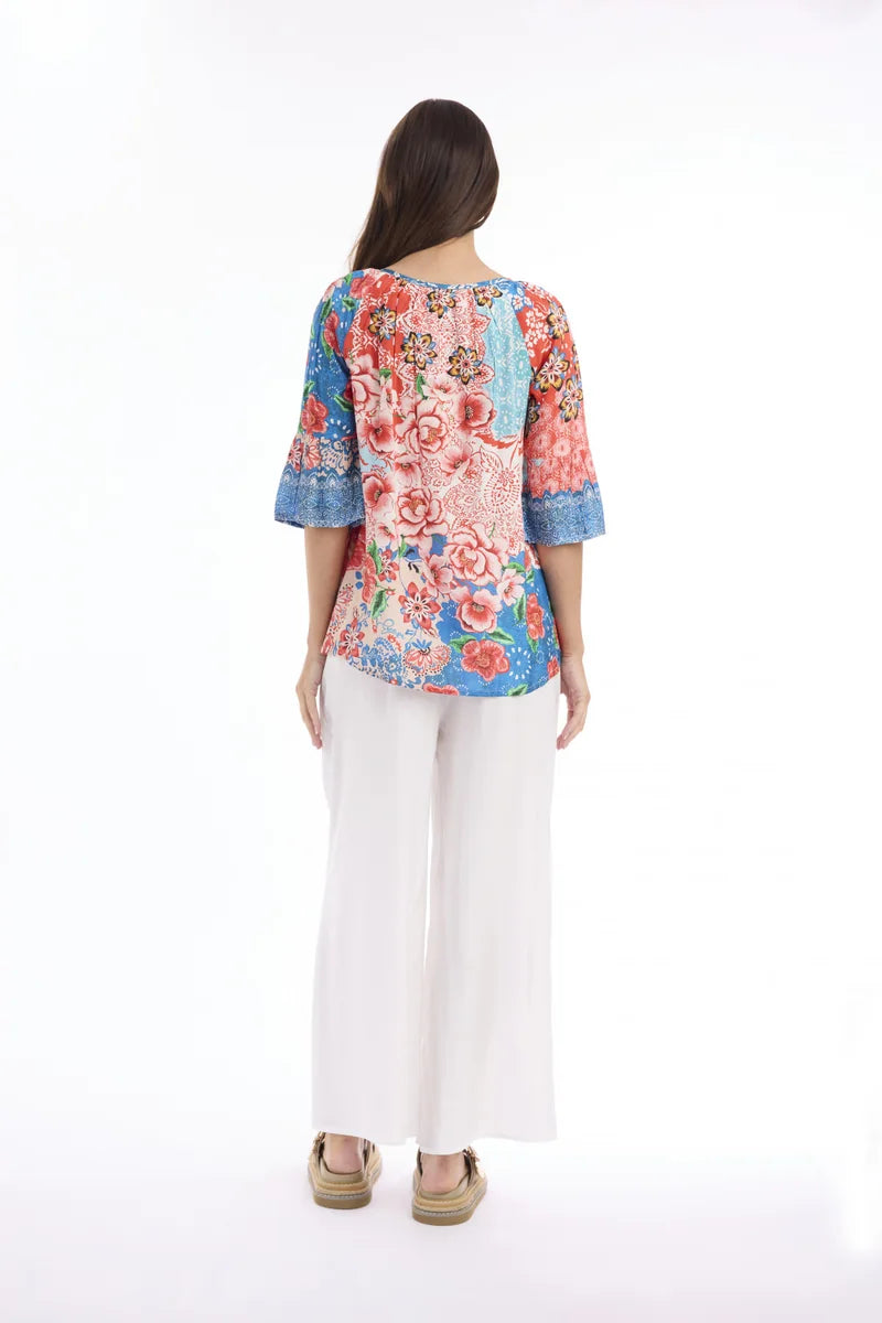 Woman wearing Escape by Orientique Clarissa Frill Sleeve Top 72589 in Print, back view