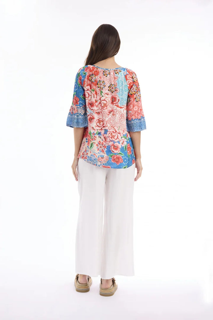 Woman wearing Escape by Orientique Clarissa Frill Sleeve Top 72589 in Print, back view