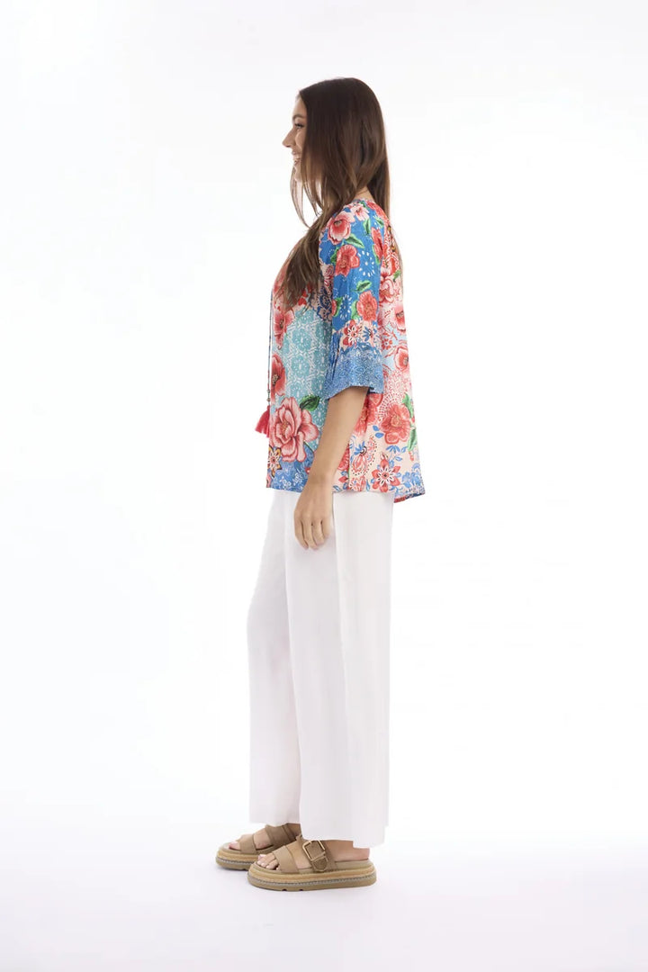 Woman wearing Escape by Orientique Clarissa Frill Sleeve Top 72589 in Print, side view