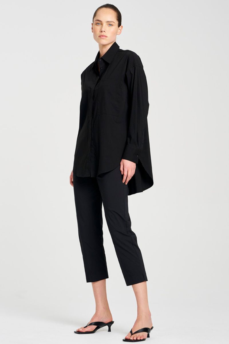 Woman wearing a black outfit on a white background