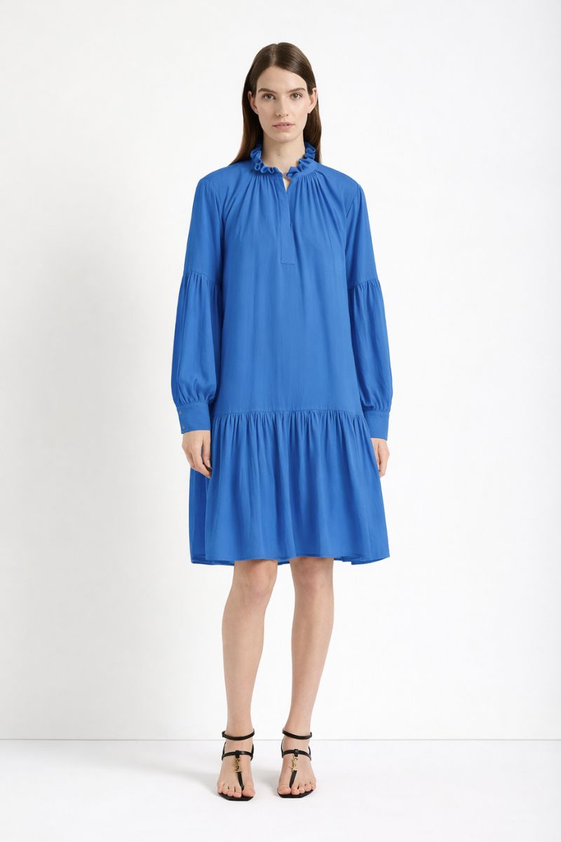 Woman wearing a blue dress on a white background