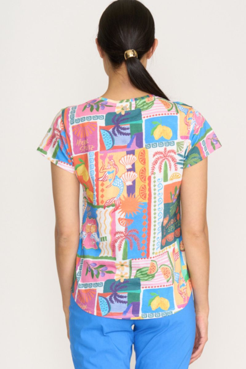 Person wearing a colorful patterned shirt with a plain background