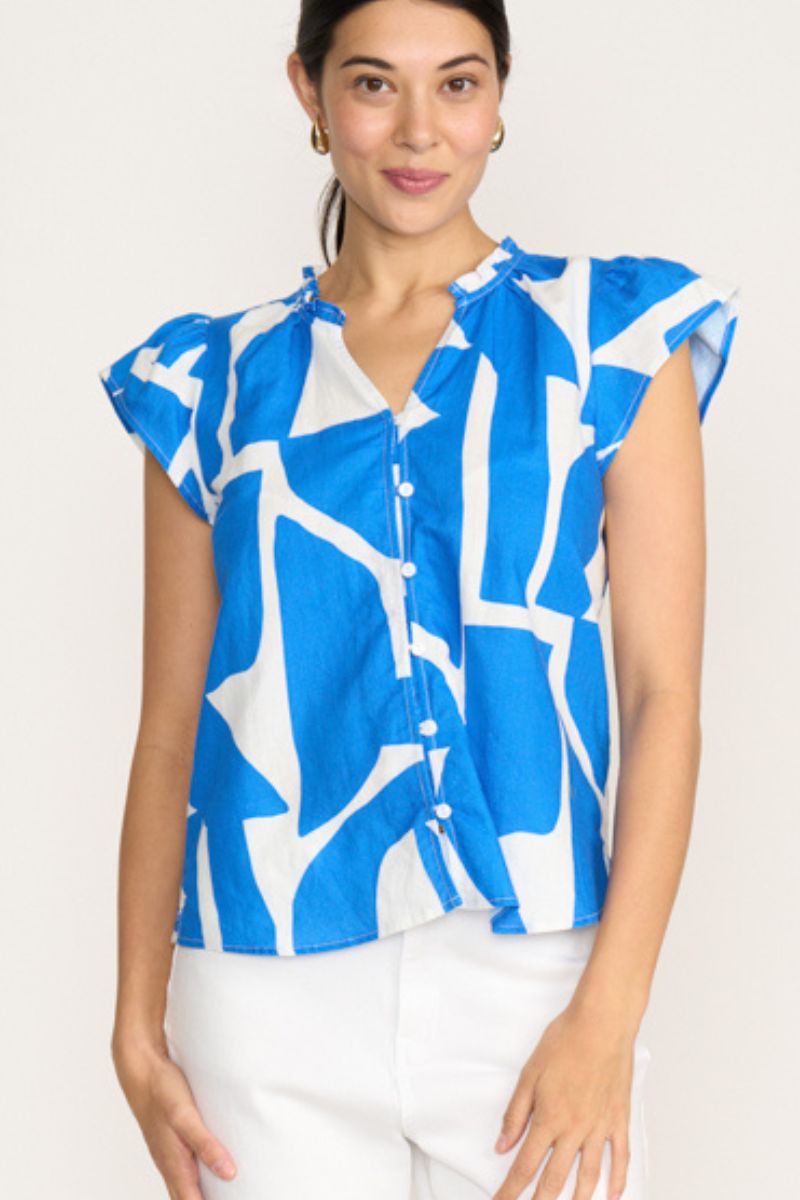 Woman wearing a blue and white patterned sleeveless blouse on a white background