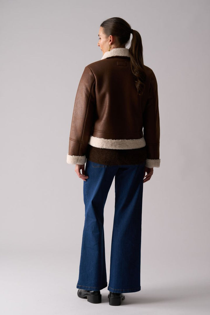 Woman wearing Flying High Jacket in Coffee by Foil back