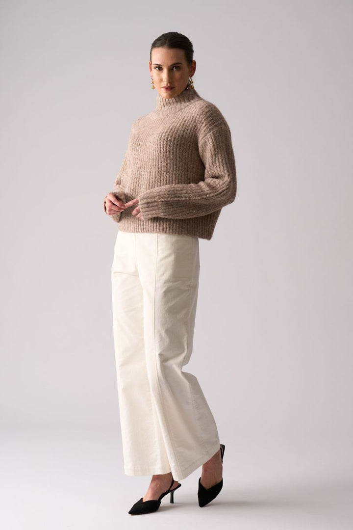 Woman wearing Glow Getter Sweater in Oat by Foil styled