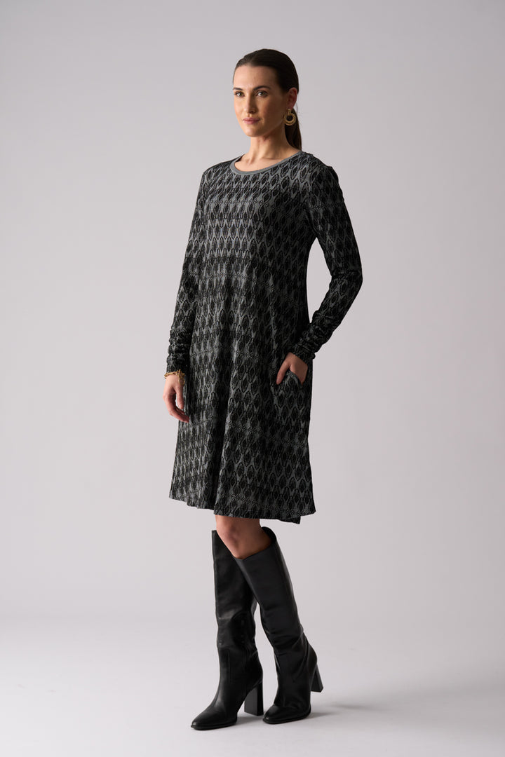 Woman wearing FOIL Loominary Dress FO8486 black knit dress angle view