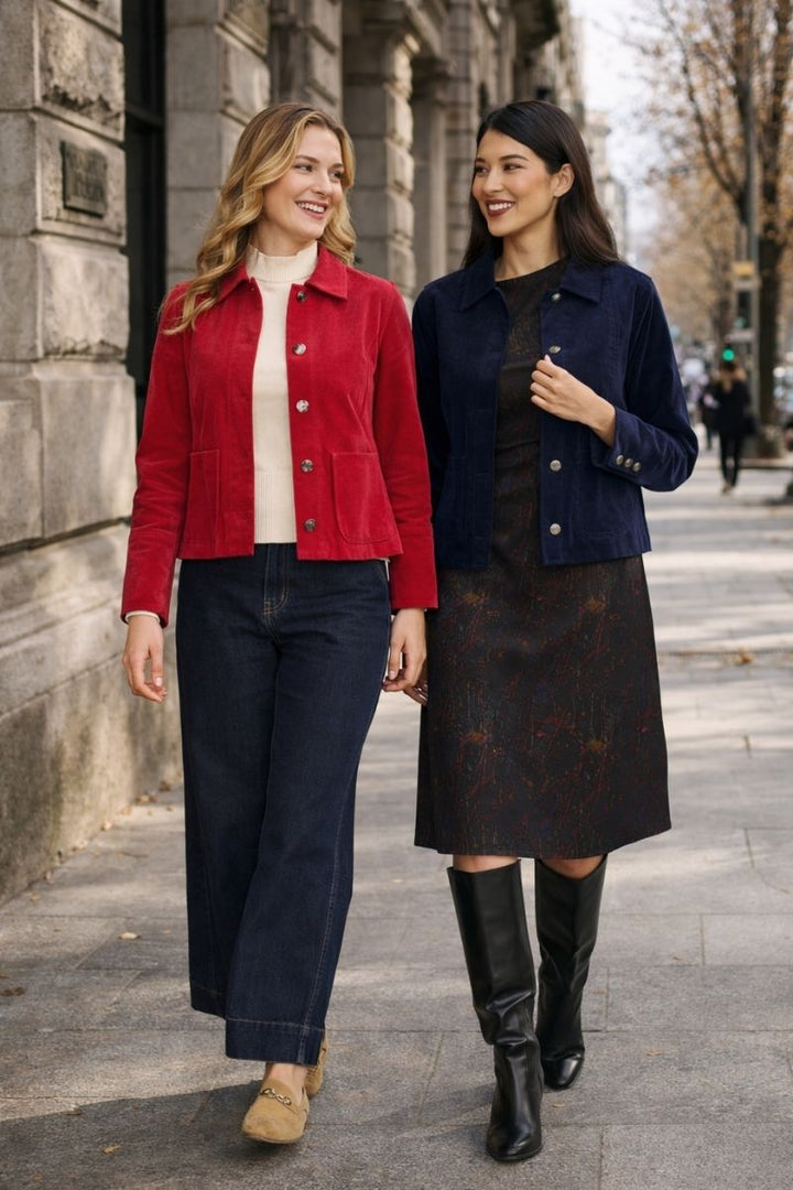 Two Women Walking wearing the pre record jackets in Rose and Navy on a street.