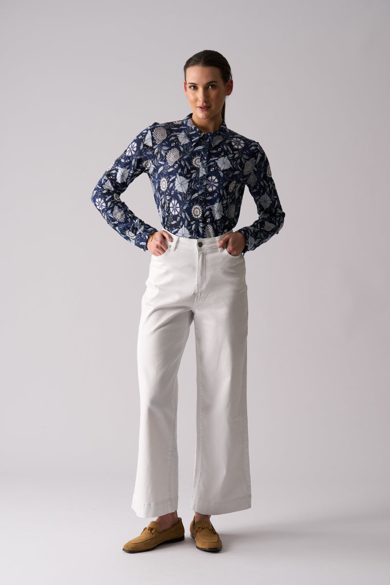 Woman wearing Risky Business Top in Bali by FOIL FO8403 styled with white wide leg pants front view