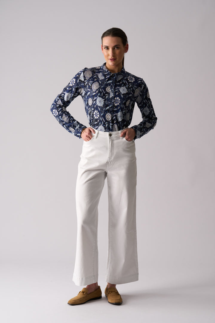 Woman wearing Risky Business Top in Bali by FOIL FO8403 styled with white wide leg pants front view