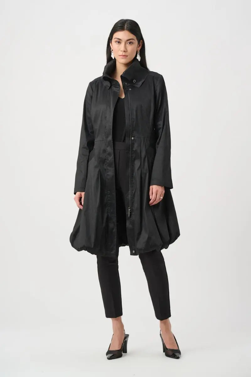 Woman wearing Joseph Ribkoff black stretch taffeta balloon coat open over black pants