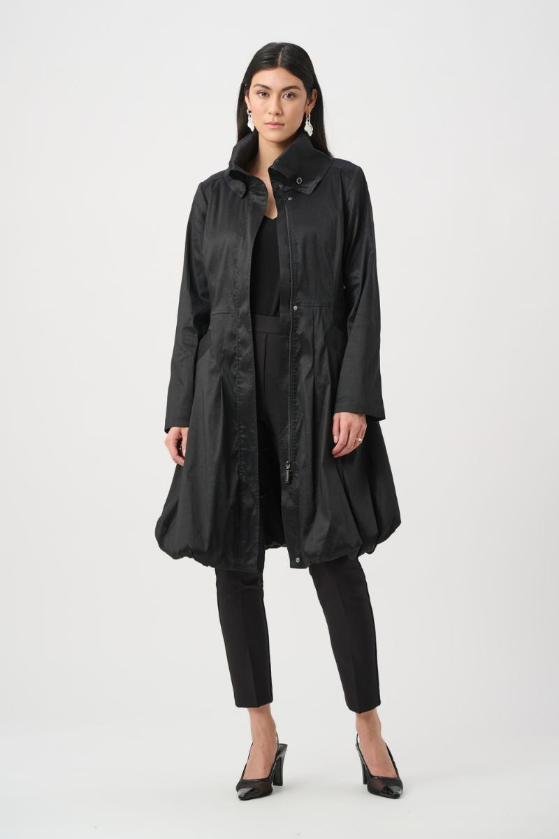 Woman wearing Joseph Ribkoff black stretch taffeta balloon coat open over black pants