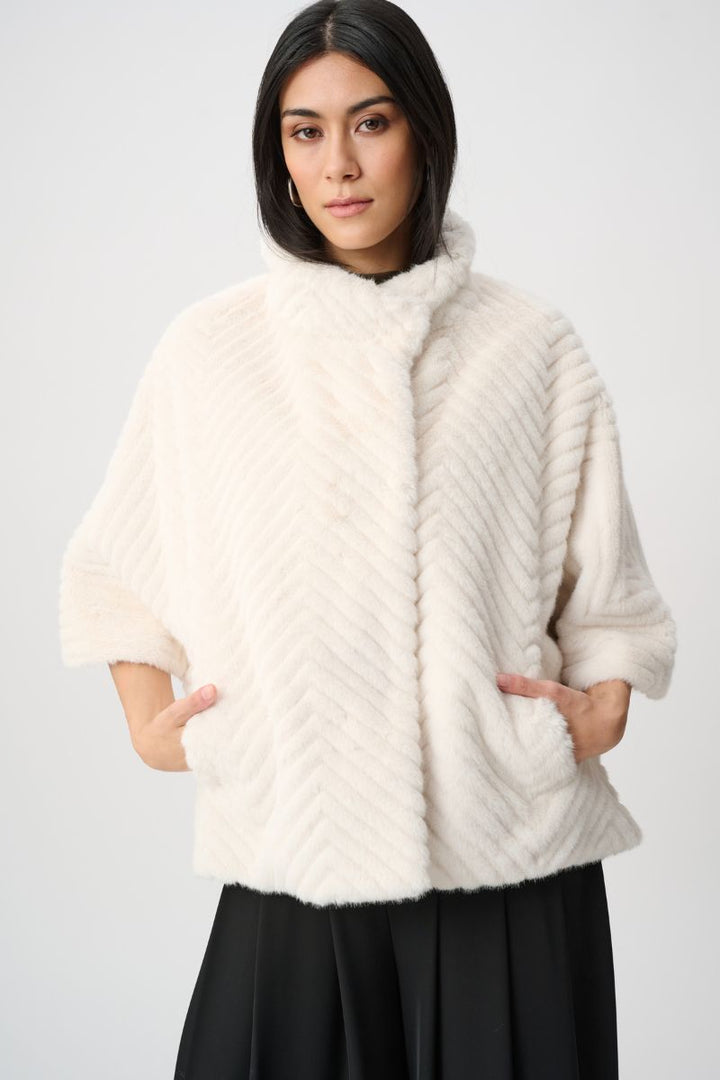 Woman wearing Joseph Ribkoff cream faux fur cape jacket collar detail