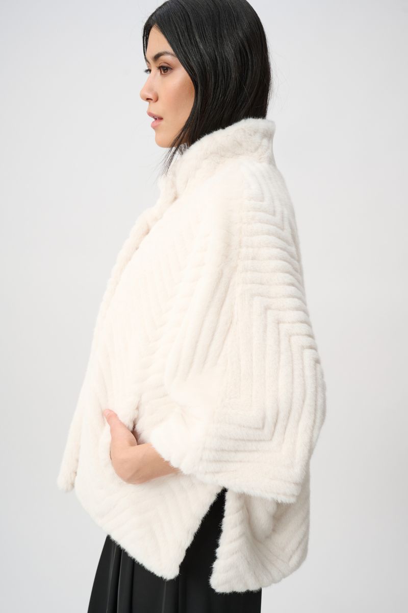 Woman wearing Joseph Ribkoff cream chevron faux fur cape jacket side view