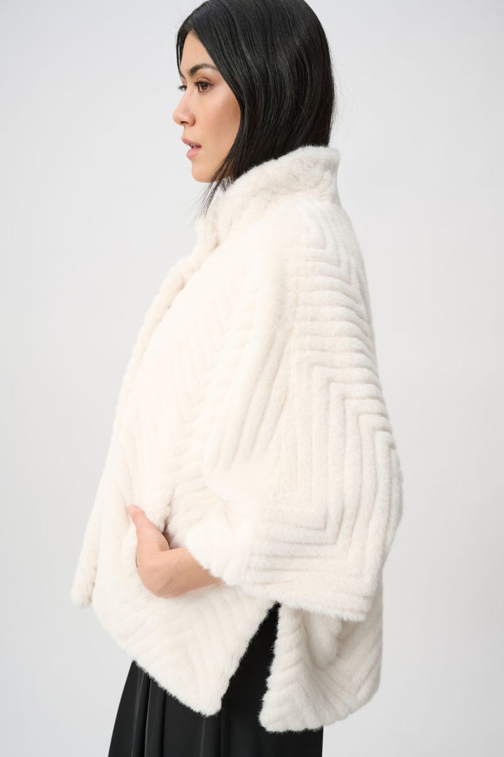 Woman wearing Joseph Ribkoff cream chevron faux fur cape jacket side view