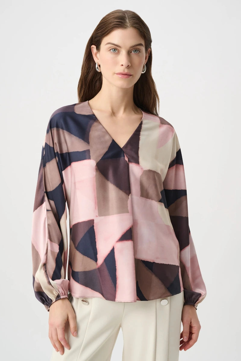 Joseph Ribkoff 264197 geometric print recycled satin top, front view showing V-neckline, boxy fit and gathered long sleeves.