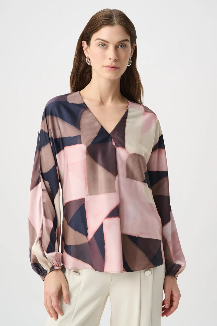 Joseph Ribkoff 264197 geometric print recycled satin top, front view showing V-neckline, boxy fit and gathered long sleeves.