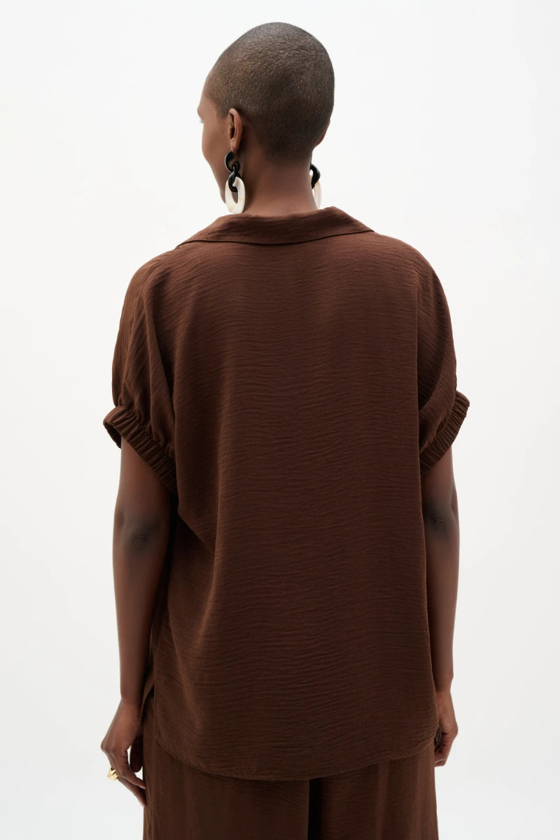 Woman wearing Woven Gauze Boxy Top With Shirred Sleeves in Mahogany by Joseph Ribkoff back view