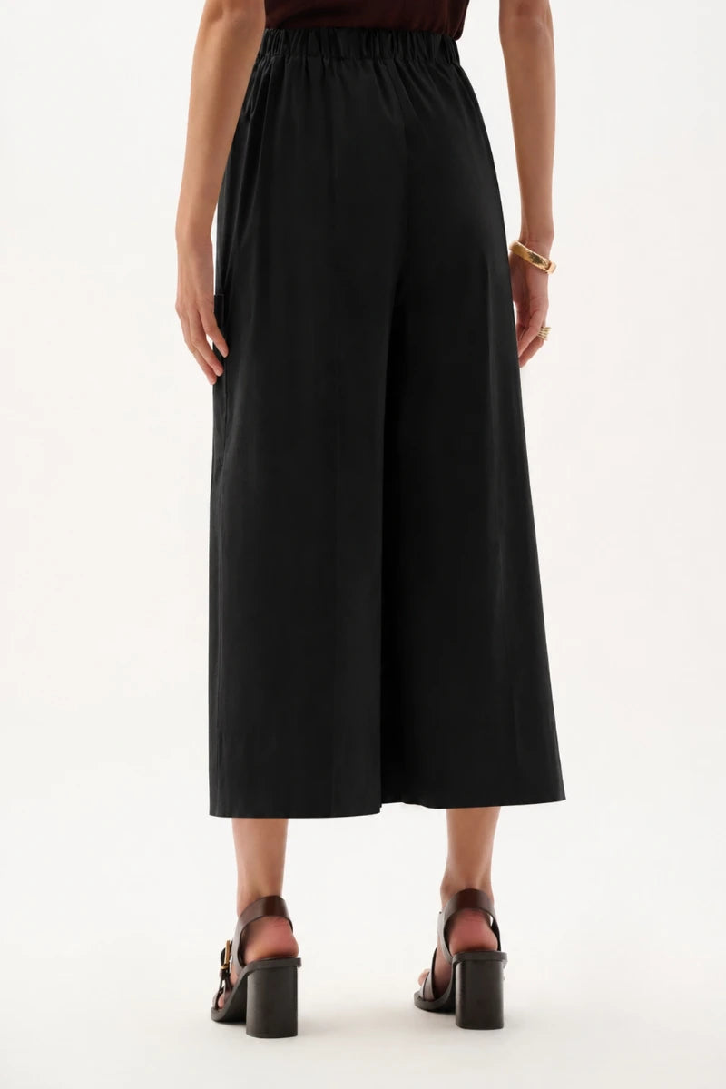Woman wearing Stretch Poplin Pull-On Culotte Pants in Black by Joseph Ribkoff back view