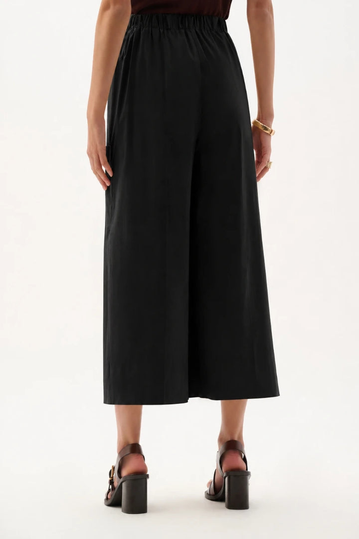 Woman wearing Stretch Poplin Pull-On Culotte Pants in Black by Joseph Ribkoff back view