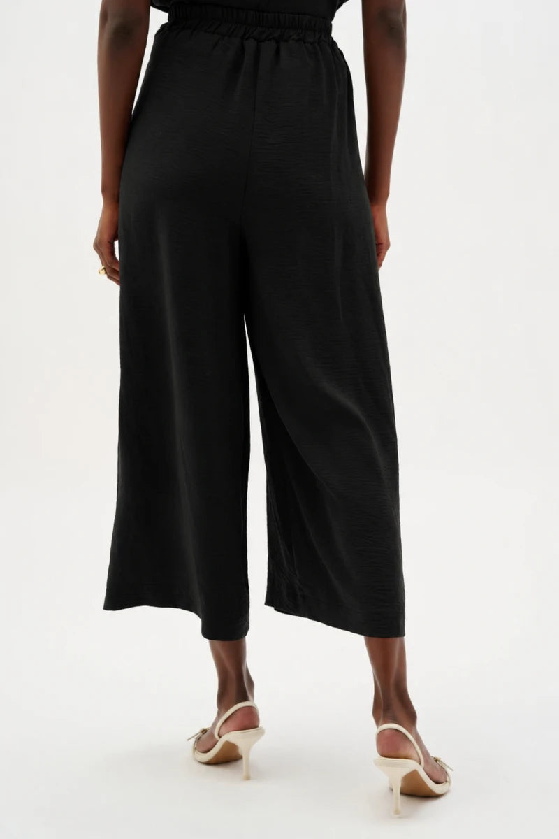 Woman wearing Gauze Pull-On Culotte Pants With Pleats in Black by Joseph Ribkoff back view