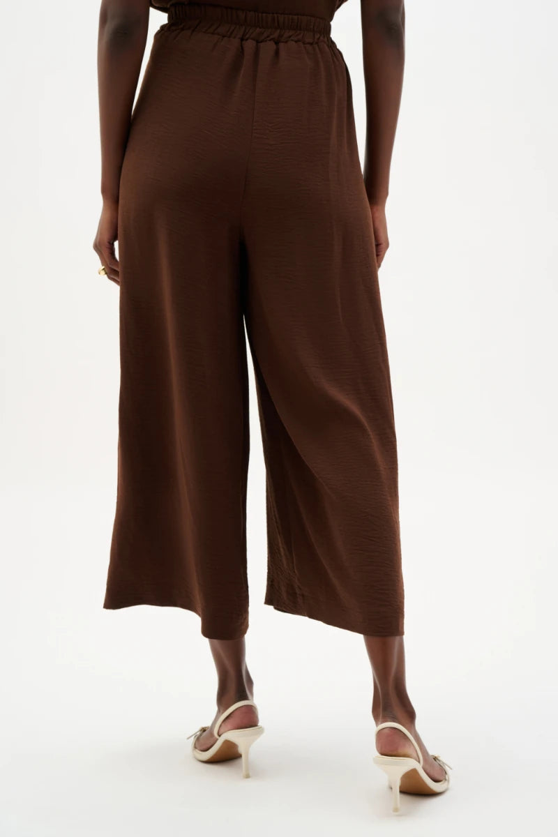 Woman wearing Gauze Pull-On Culotte Pants With Pleats in Mahogany by Joseph Ribkoff back view