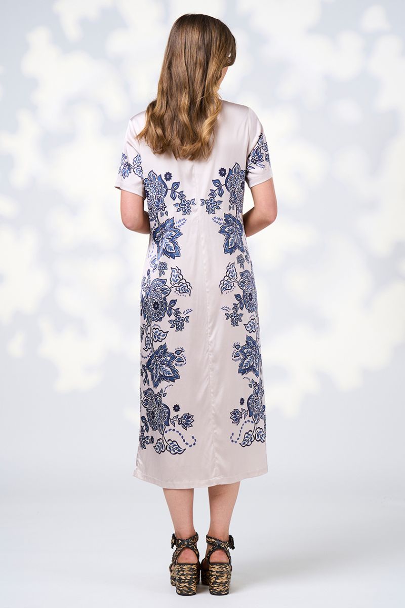 Woman wearing a floral dress with a white background BACK VIEW