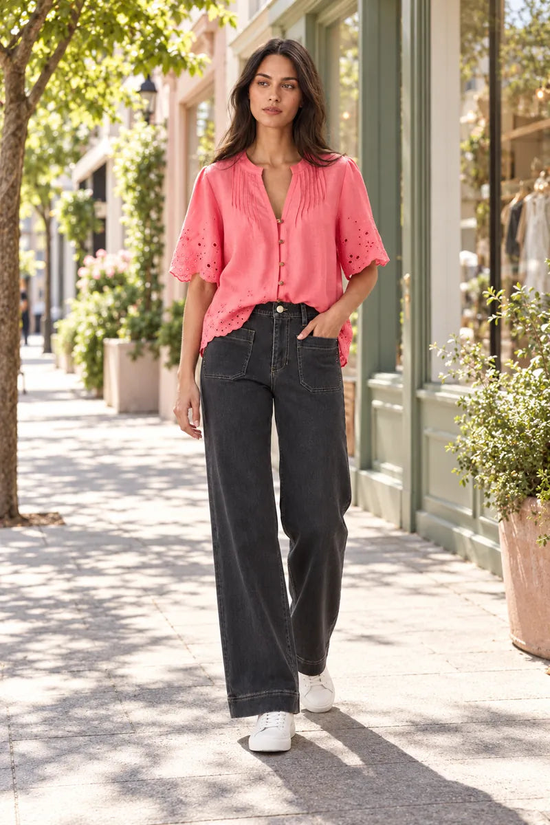 Lania Chrome jeans in Charcoal styled with the Kasia shirt in Coral and white sneakers on a sunny town shopping street