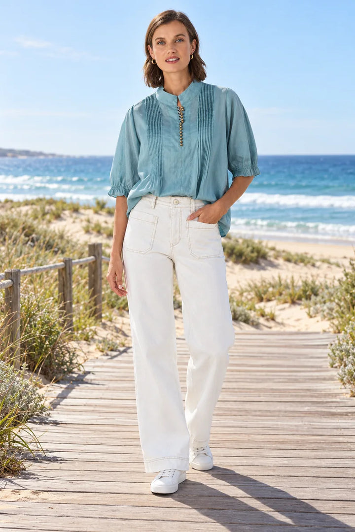 Lania Chrome jeans in White styled with the Pier Shirt in Seafoam on a sunny coastal boardwalk
