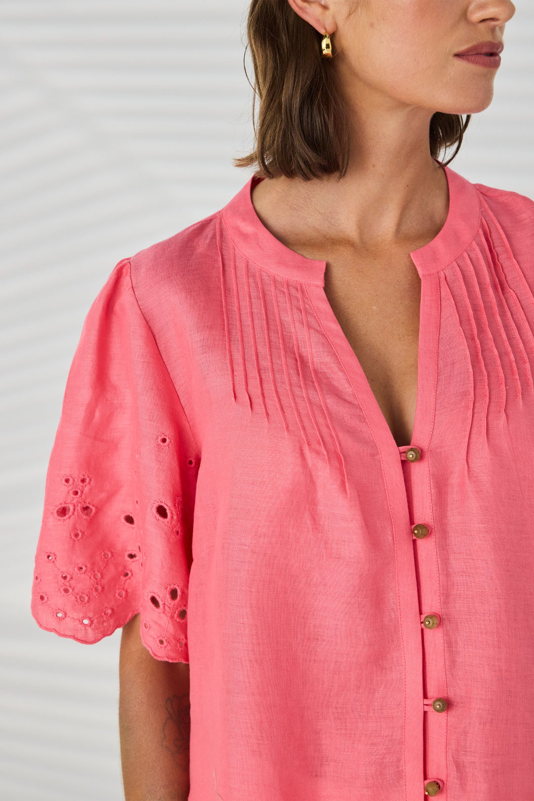 Lania the Label Kasia Shirt NLA4076 in Coral, close-up showing pintuck neckline, button front and embroidered sleeve detail