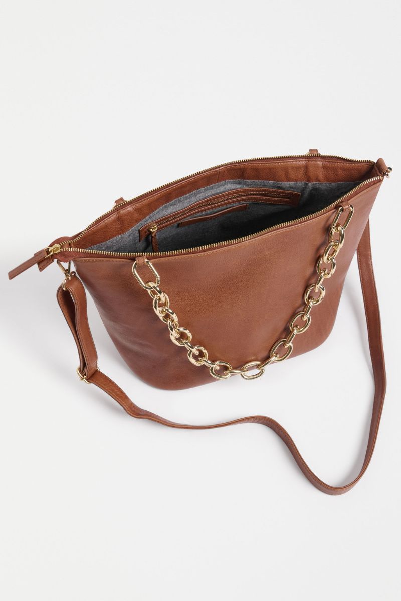 Brown leather handbag with gold chain detail on a white background