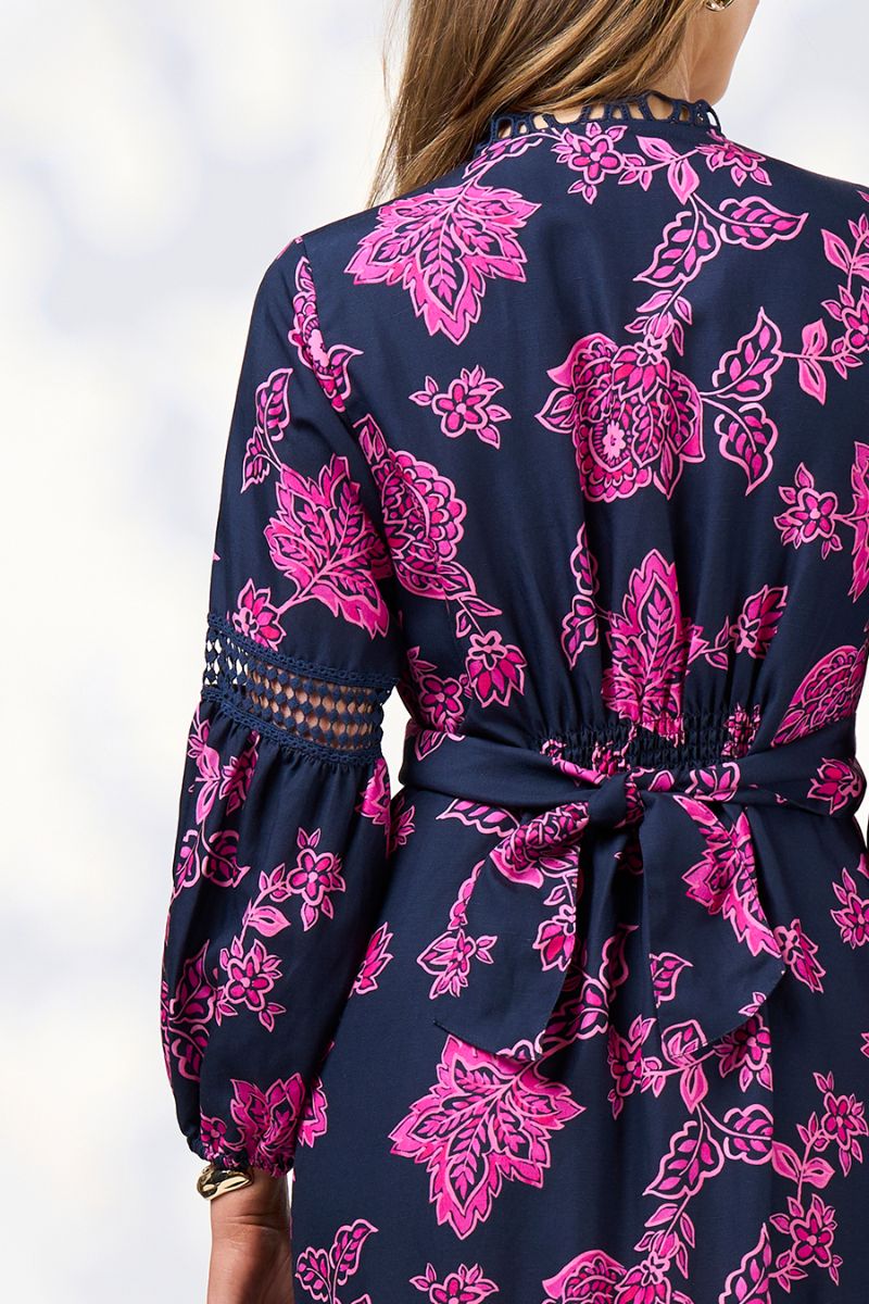 Back view of Navy blue dress with pink floral patterns on a white background