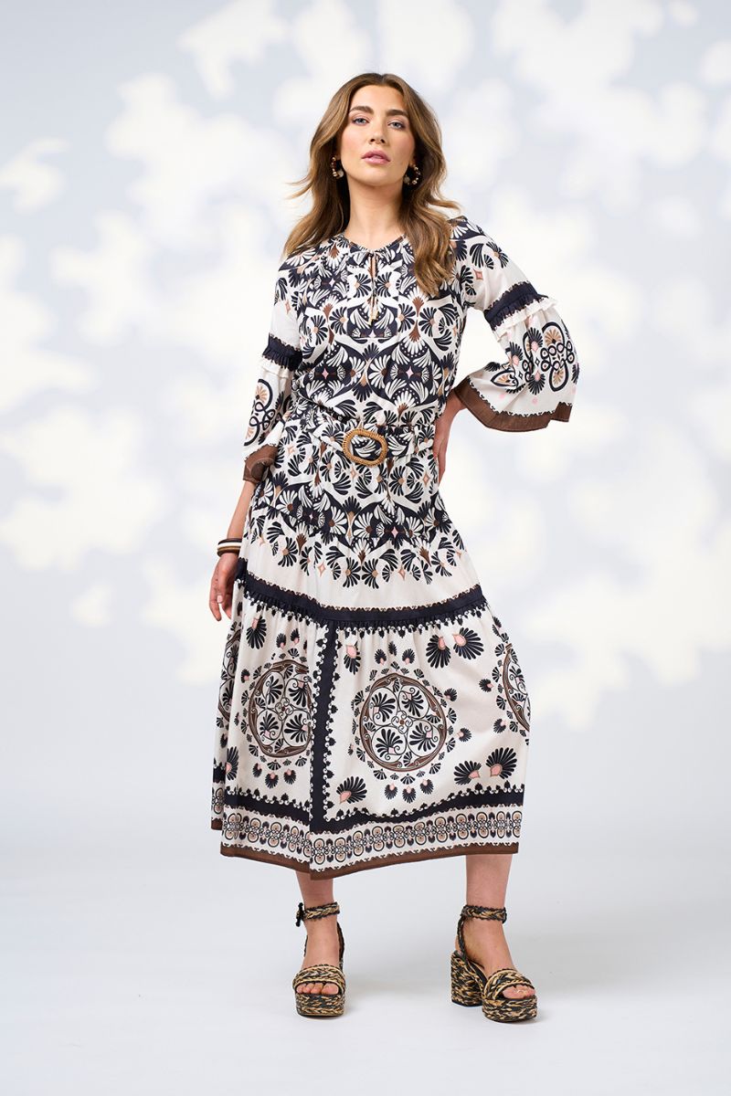 woman wearing patterned blouse and skirt 