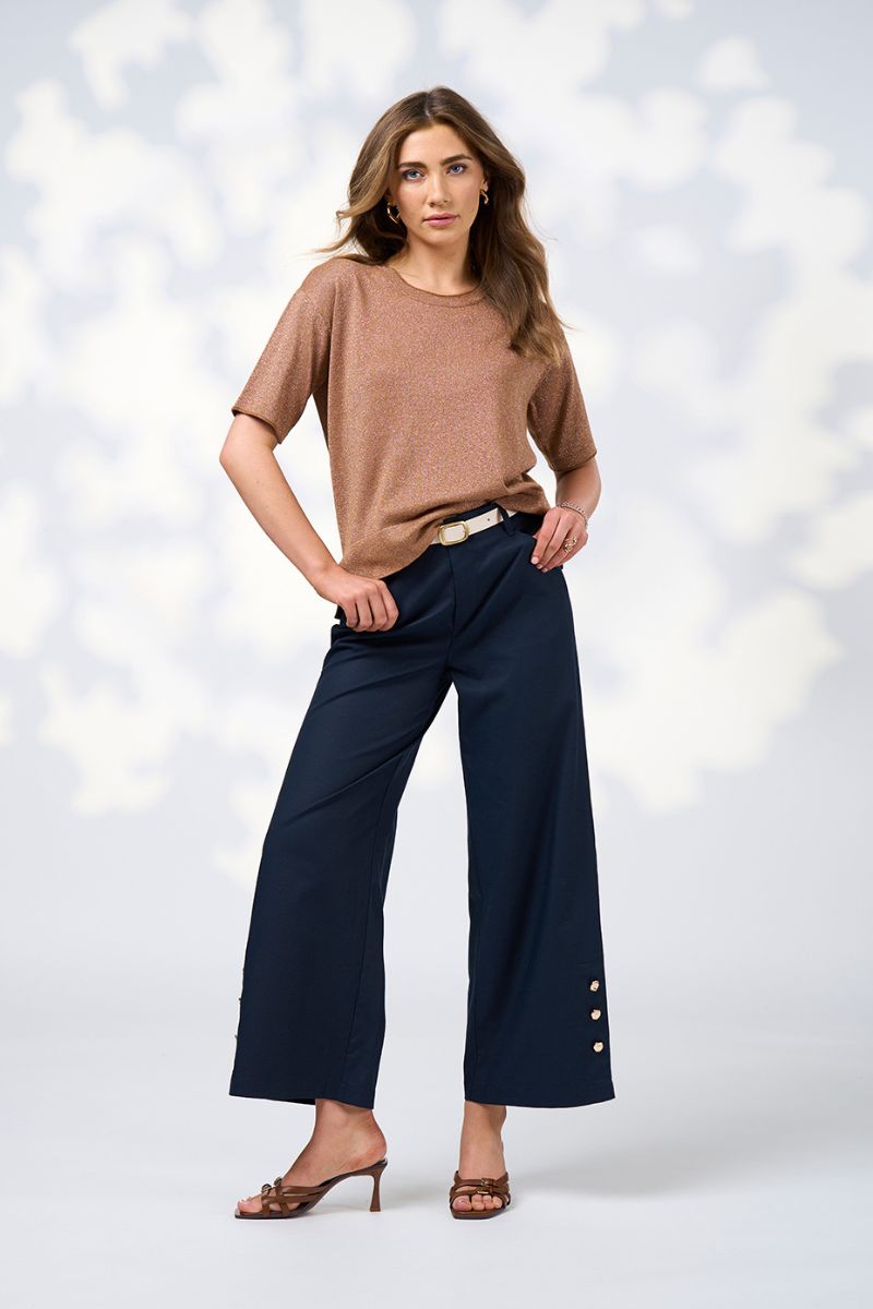 WOMEN IN SHIMMER BRONZE TOP AND WIDE NAVY PANTS