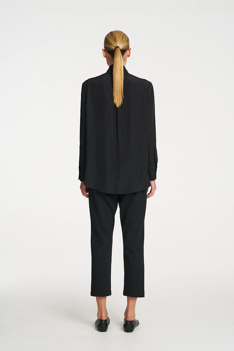 Woman wearing Mela Purdie Balcony Blouse F67 8970 in Black, back view showing the centre-back pleat